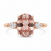 Rose gold ring with a large pink gemstone and smaller white gemstones on a white background